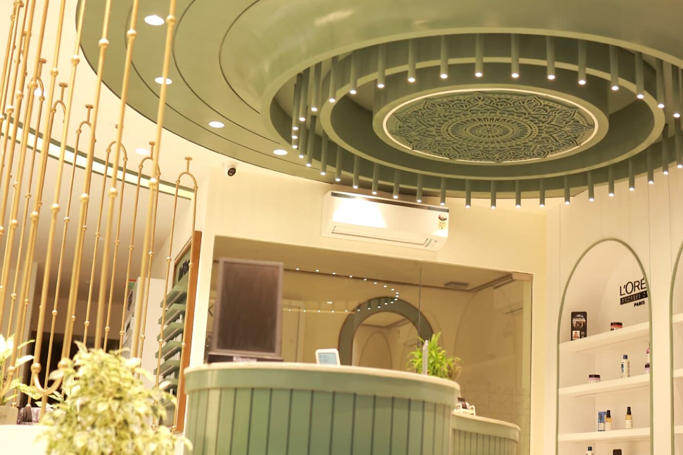 Luxury reception area at Page 3 Salon, KK Nagar East, Madurai, with warm lighting and a styling counter