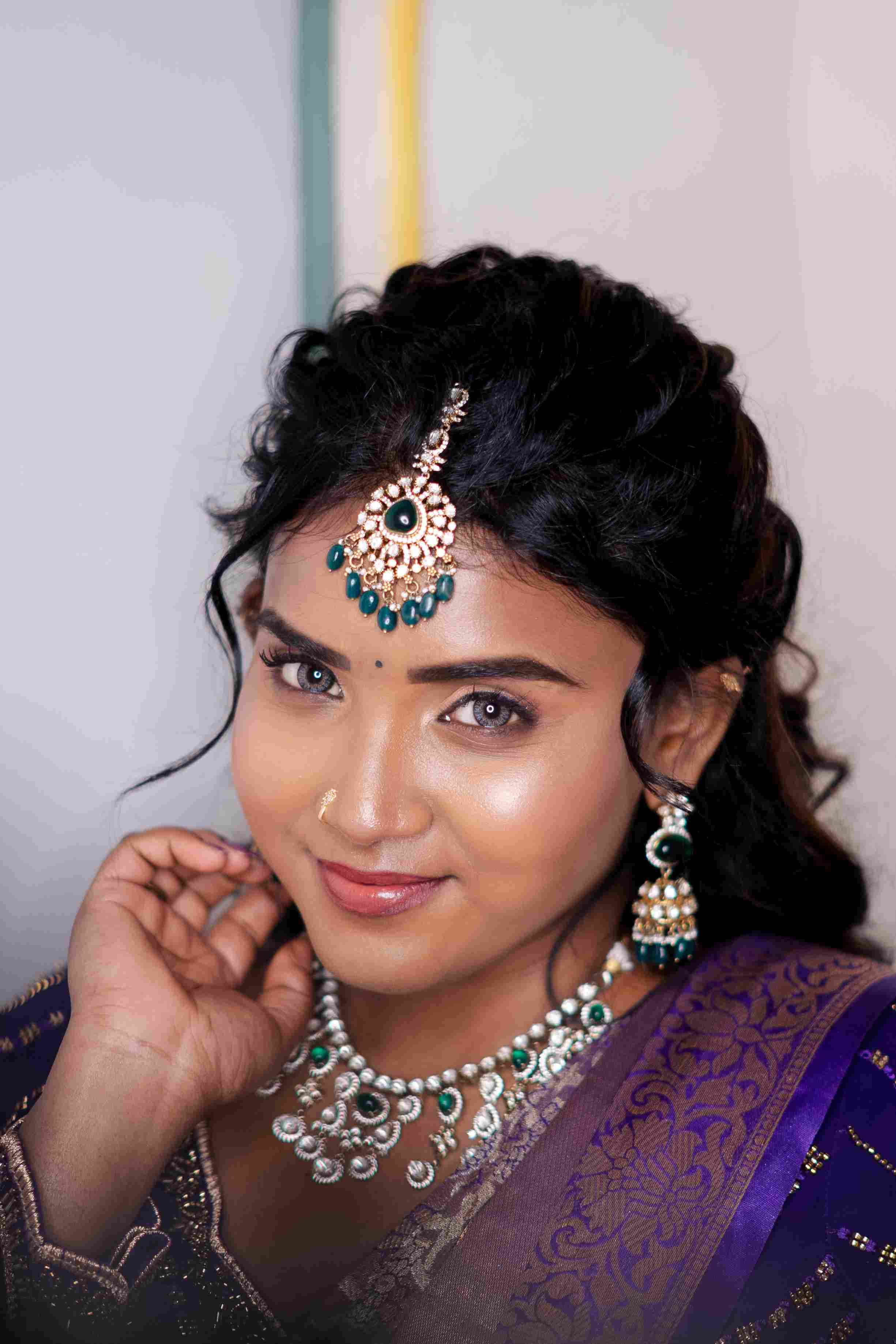 Bride with a glowing base, defined eyes, maang tikka and temple jewellery after bridal makeup at Page 3 Luxury Salon, KK Nagar East, Madurai